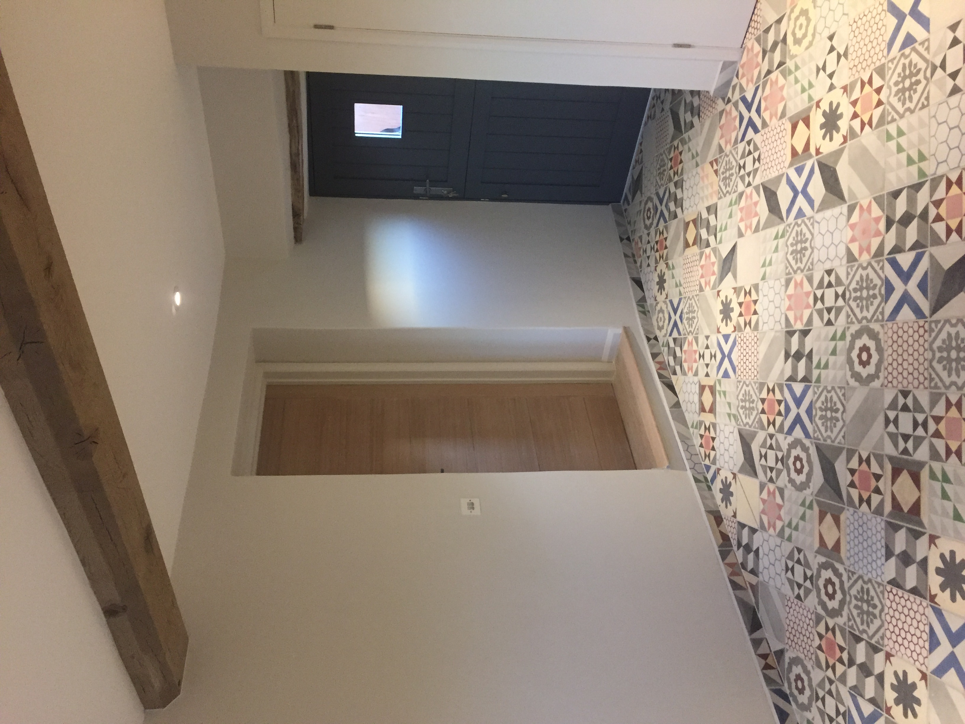 Hallway with encaustic tiles, oak door and traditional stable door in heritage navy