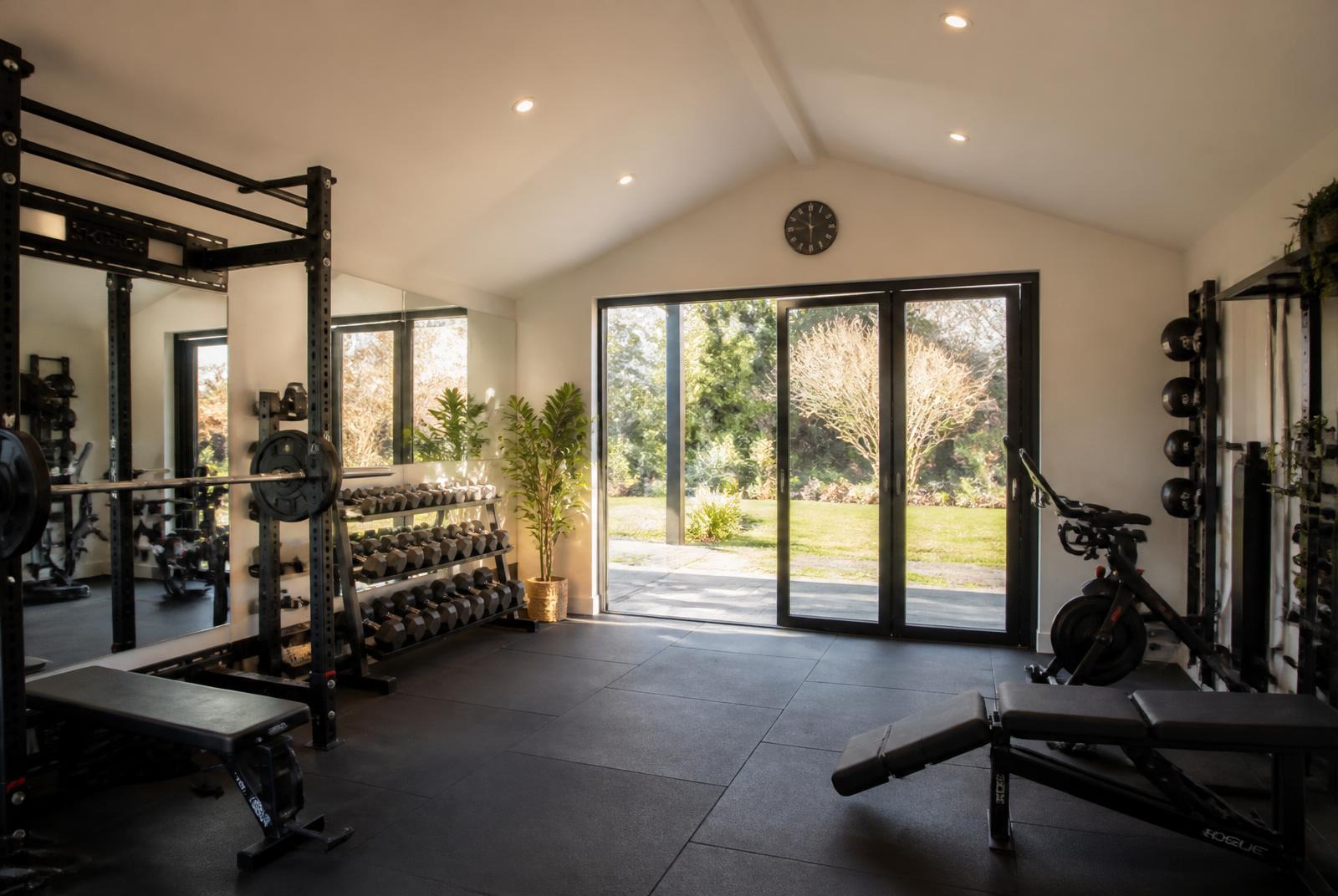 Premium home gym inside a bright garden studio