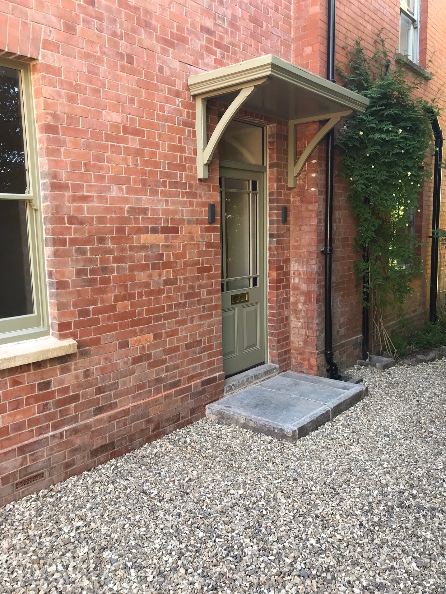 Front entrance with sage timber porch and reclaimed brick surround