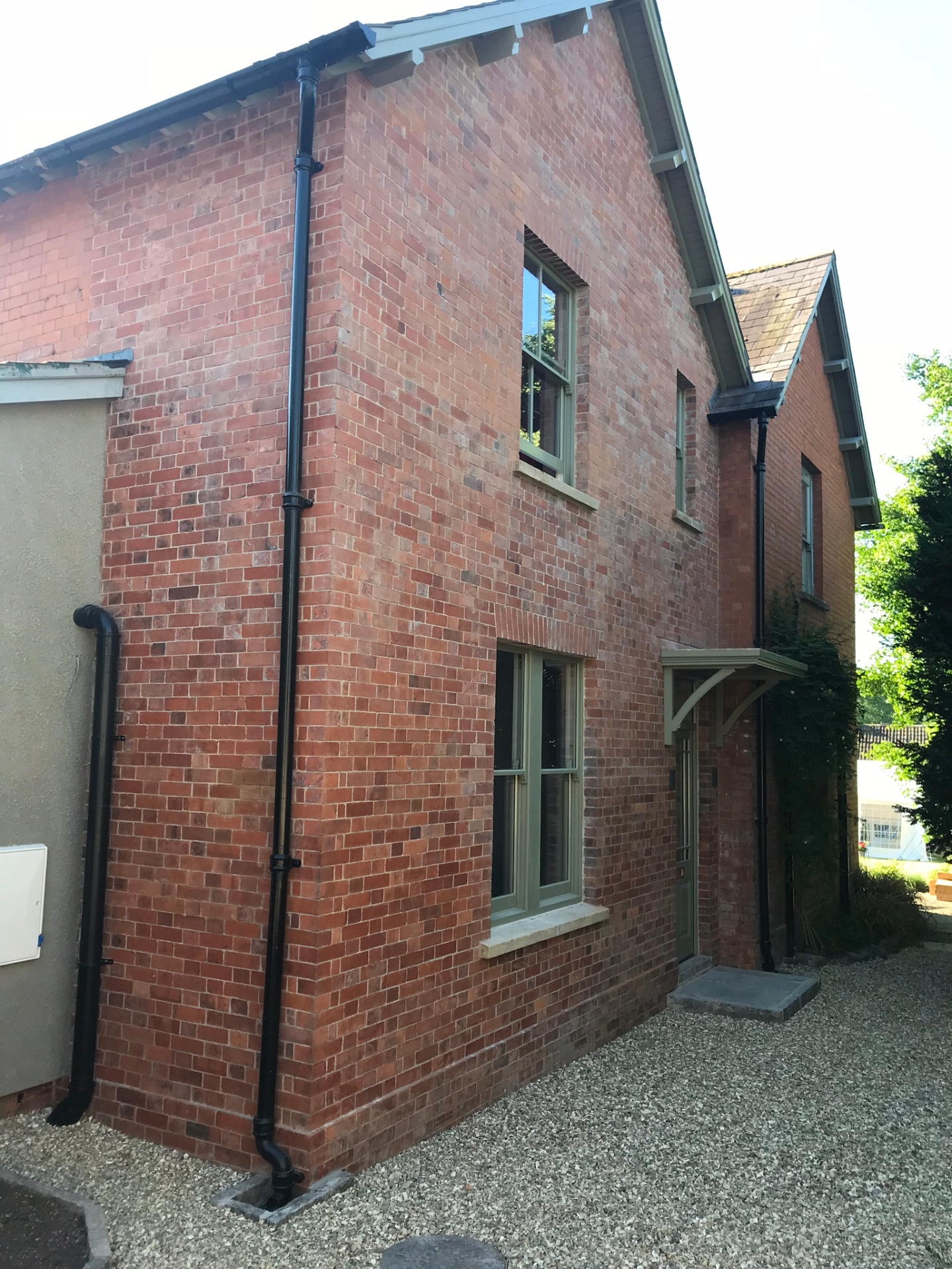 Side elevation of the extended gable showing sash windows and heritage brickwork