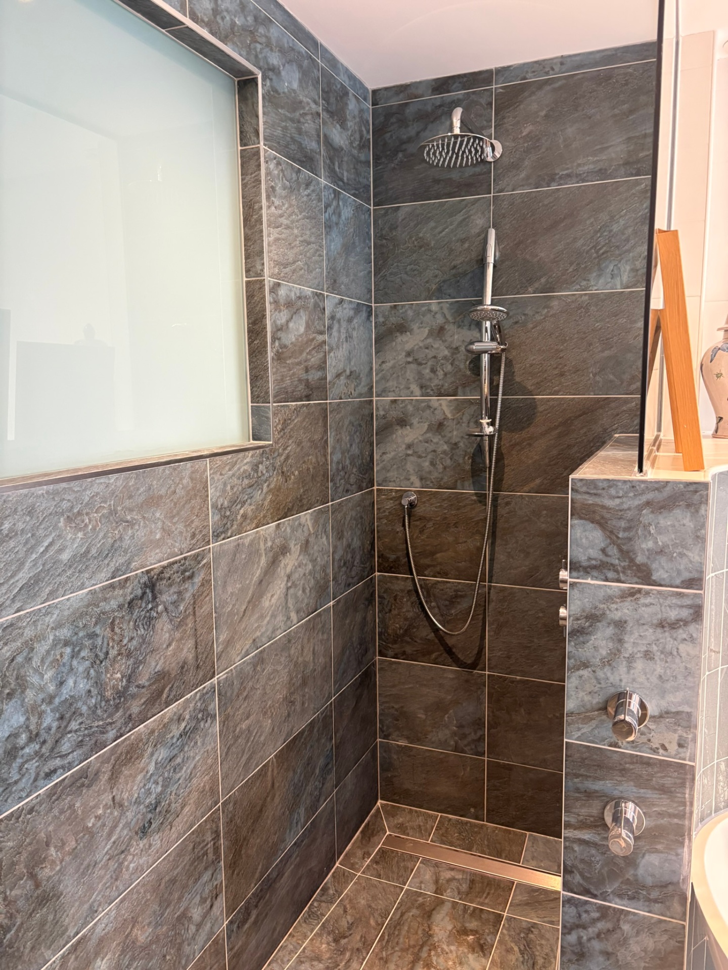 Slate-effect walk-in shower with chrome rainfall head