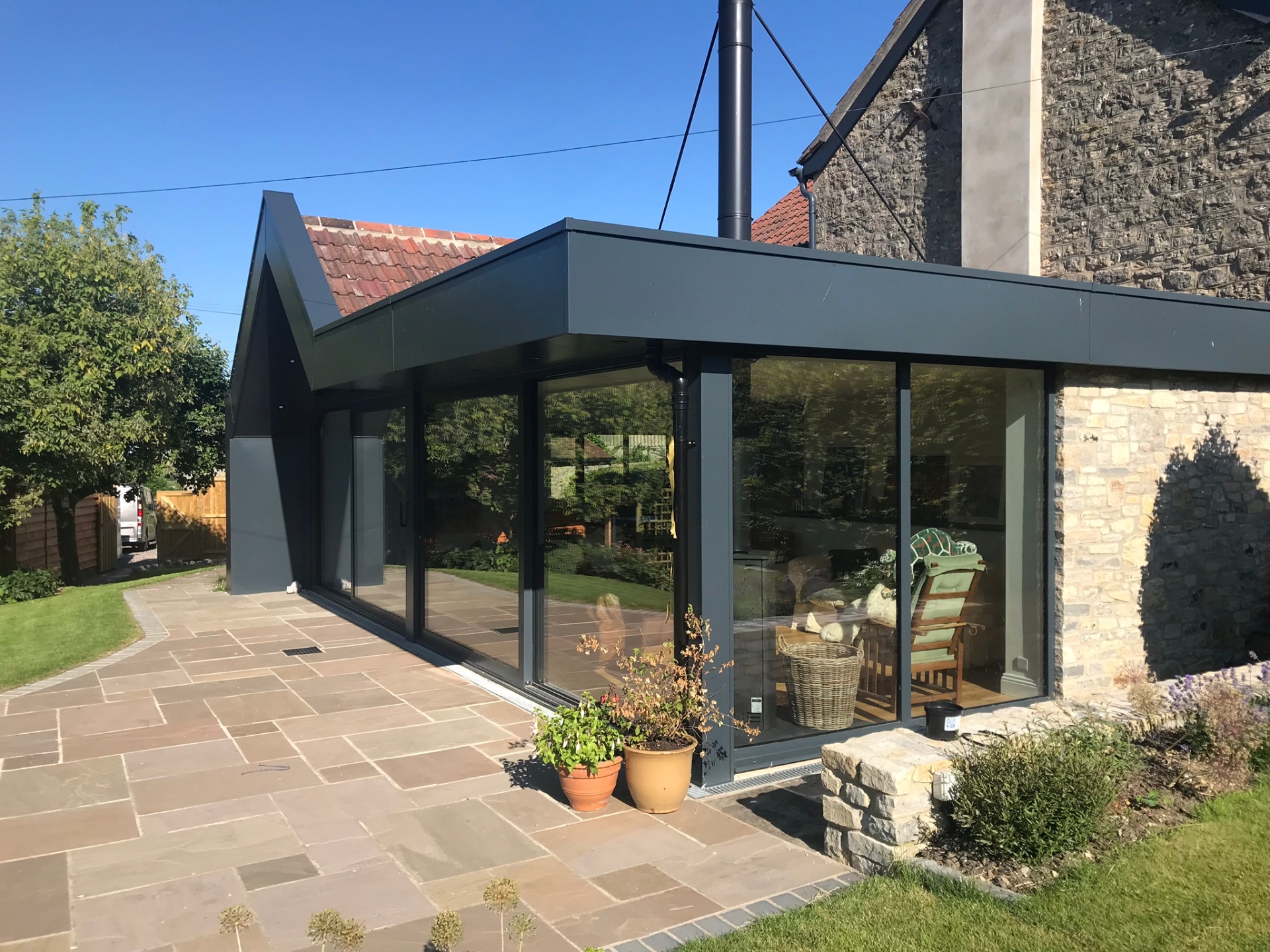 Zinc-clad extension with full-height sliding glass doors