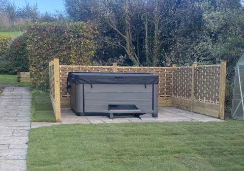 Hot tub area on paved base with timber trellis screening