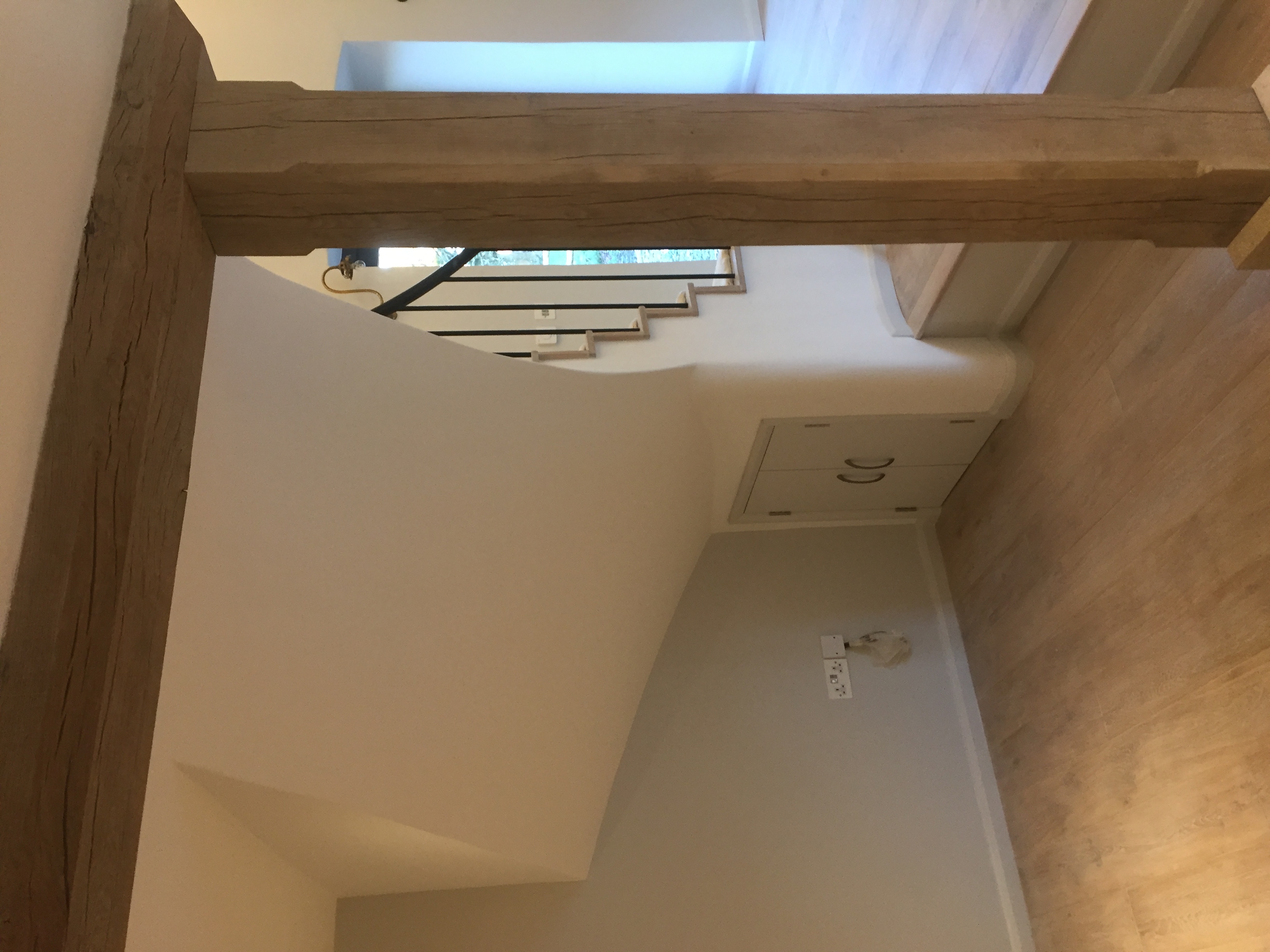 Ground-floor landing with oak beam and built-in understair cupboard