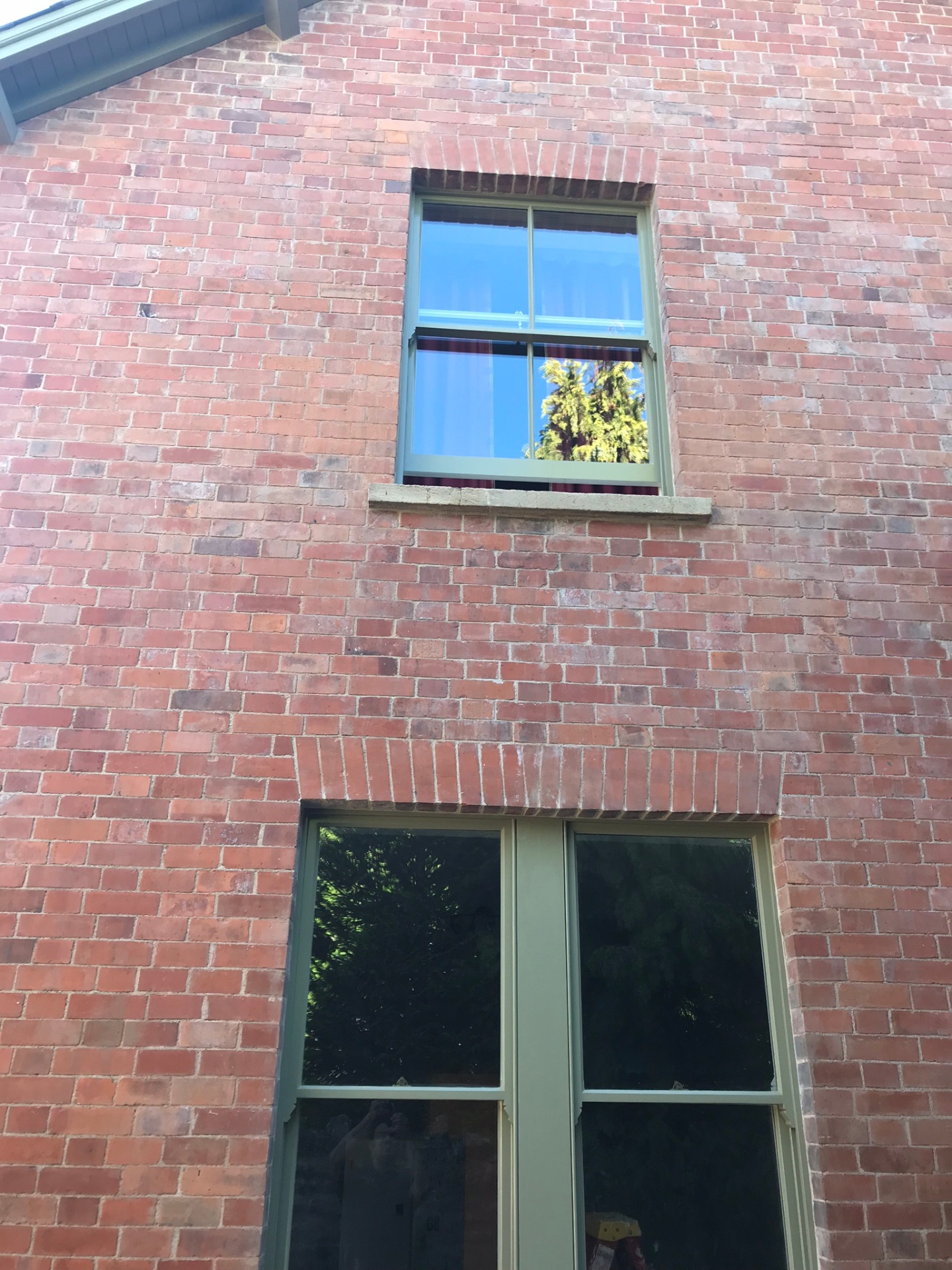 Restored red brick elevation with new sage sash windows