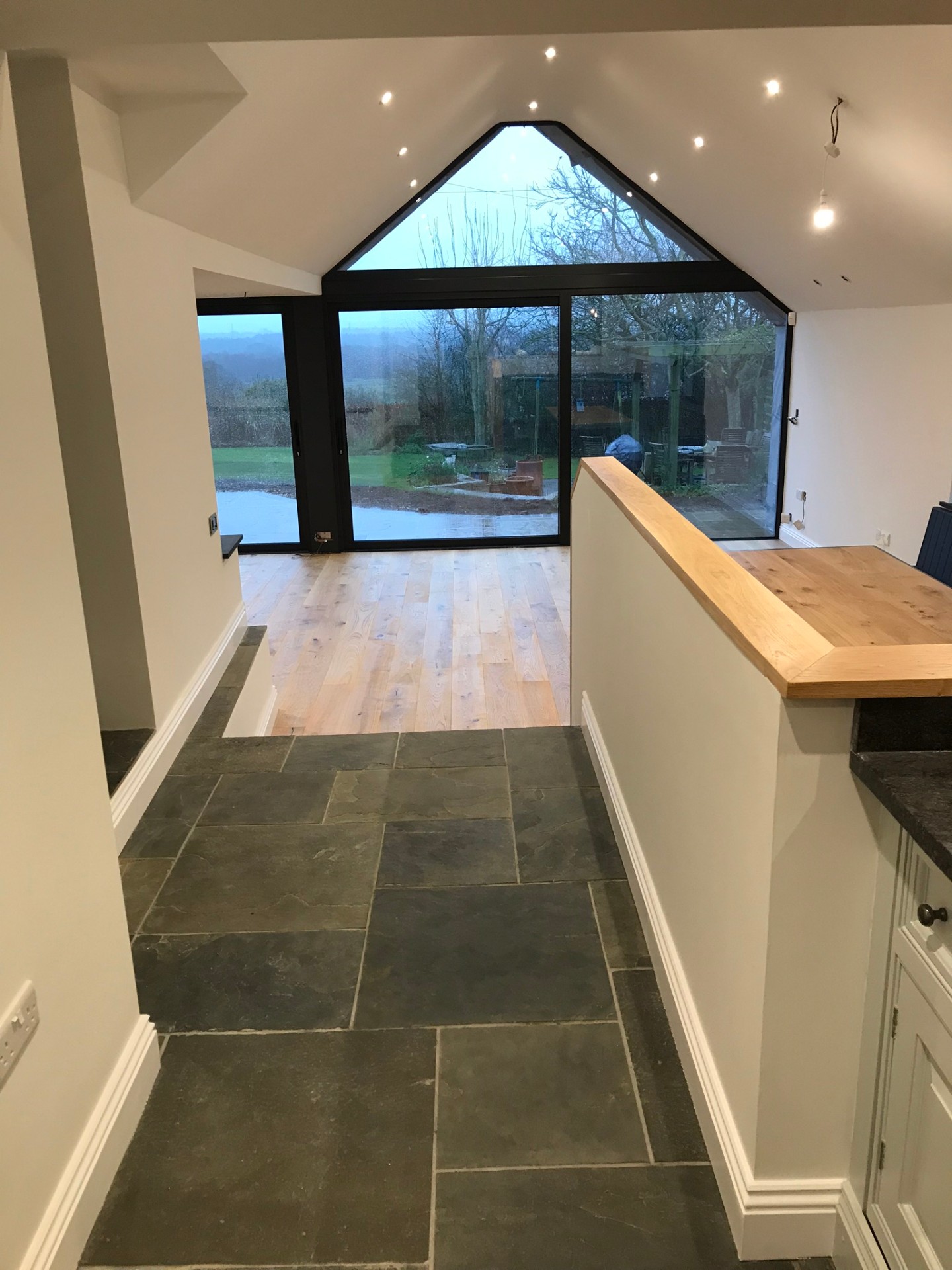 Interior view from kitchen looking through to garden through gable-end glazing