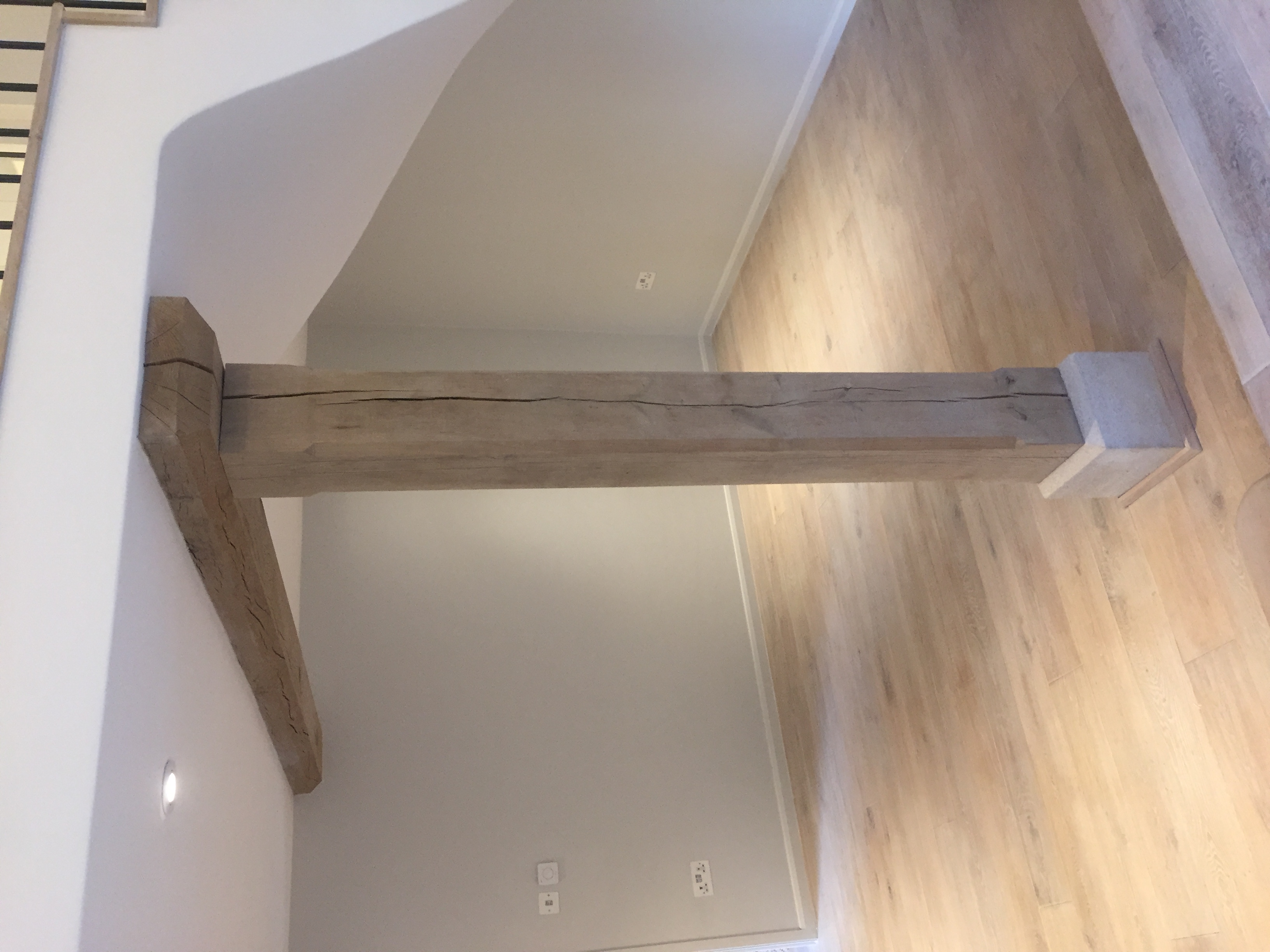 Oak post supporting original beam beneath the mezzanine gallery